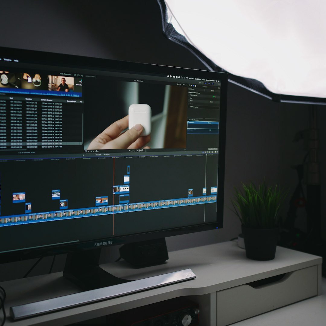Swiss woman in her forties reviewing archive footage at an editing desk